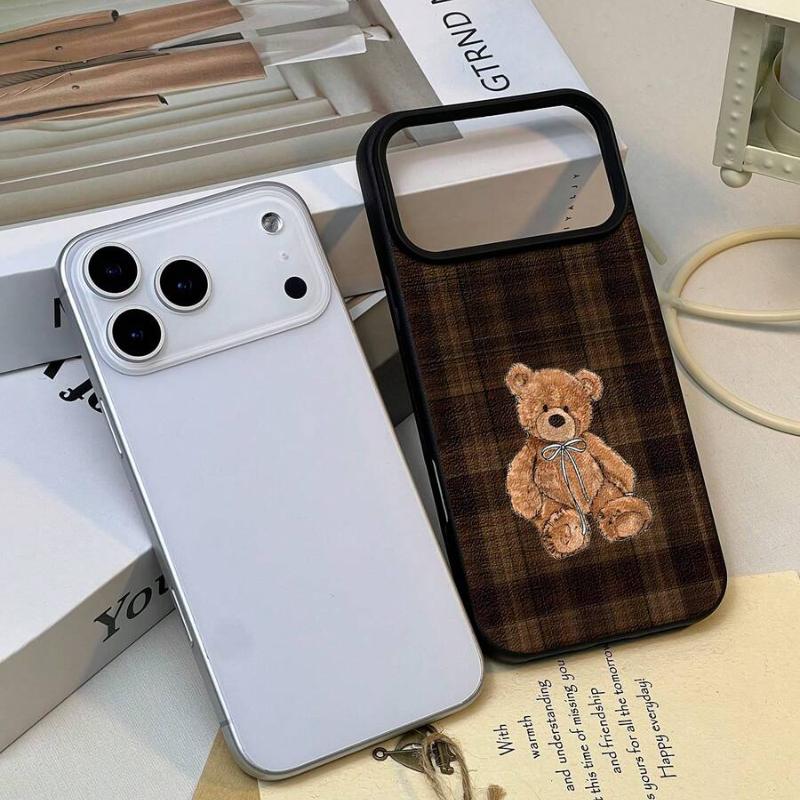Teddy Bear Phone Case - angled on a notebook, full plaid back and teddy bear
